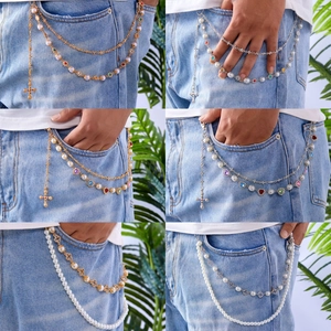 Hip hop layered pants chain with pearls, colorful rhinestones, and cross charms on denim