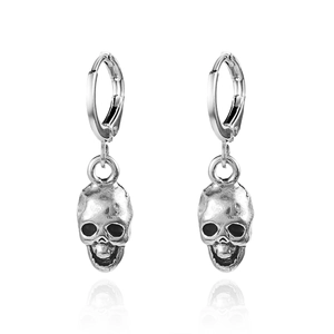 Macro detail of silver skull earrings with vintage finish and hoop design on white background