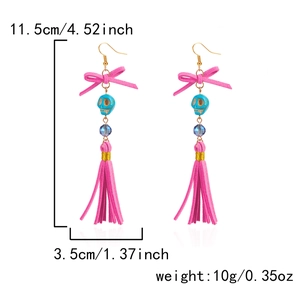 Pink bohemian tassel earrings with skull beads and crystal accents for Halloween