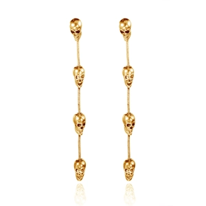 Detail view of golden skull tassel earrings with stacked skeletons and metallic finish
