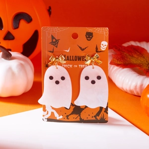 Close-up of Halloween ghost earrings with gold bows on a festive orange themed display card