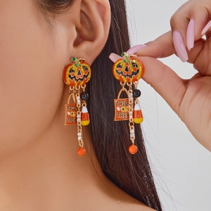 Detail of Halloween pumpkin earrings with Trick or Treat tag and sparkling crystal fringe