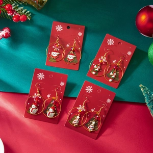 Christmas hoop earring set with Santa, candy cane, and tree charms on red display cards