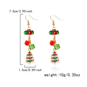 Detailed view of Christmas tree drop earrings with red beads and golden bells