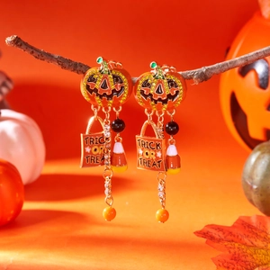 Detailed Halloween tassel earrings featuring Jack-o'-lantern studs and Trick or Treat charms