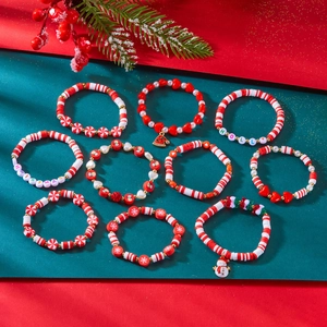 Detailed close-up of 10-piece Christmas clay bead bracelets with festive holiday charms
