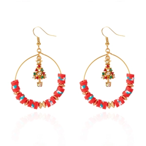 Detail of Christmas hoop earrings with a small tree pendant and red clay accents