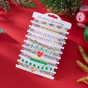 Macro detail of 10-piece Christmas clay bead bracelet set with festive charms and letters