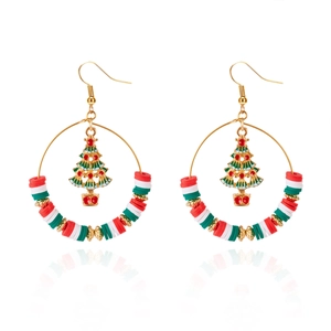 Detailed view of Christmas hoop earrings with red green polymer clay and festive tree charm
