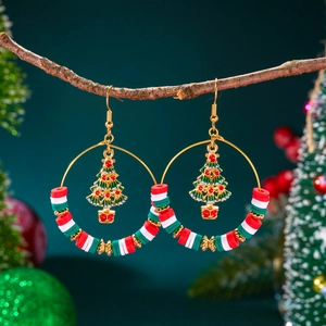 Detail of Christmas hoop earrings with polymer clay beads and a golden tree charm