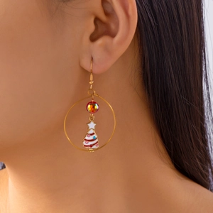 Close-up of Christmas tree earring with enamel finish and iridescent glass bead