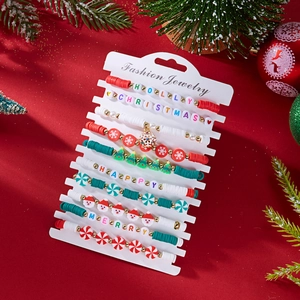 Detailed view of Christmas polymer clay bead bracelet set with festive charms on card