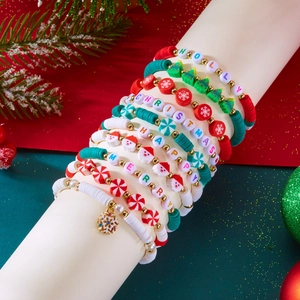 Detail of Christmas multi-layer beaded bracelet set with clay discs and holiday charms