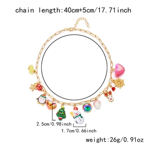 Detail of Christmas necklace with snowman, reindeer, and snowflake charms on a golden chain