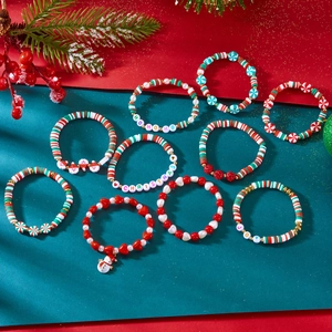 Detail of Christmas beaded bracelet set with clay beads, charms and holiday letter beads