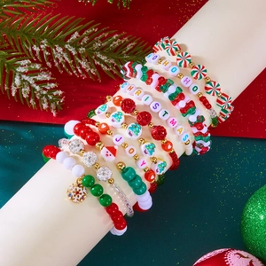 Detail of Christmas beaded bracelet set featuring red and green acrylic festive charms