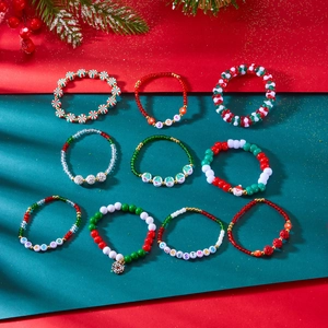 Detailed view of colorful Christmas beaded bracelets set with festive charms and joy text