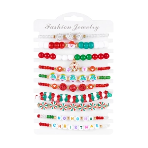 Close-up of 10 Christmas beaded bracelets with Santa, tree, and JOY letter charms