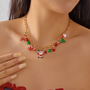 Dettaglio di una collana natalizia dorata con ciondoli di Babbo Natale, renne e perle colorate