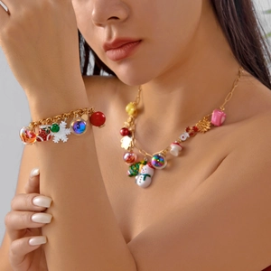 Close-up of a festive Christmas jewelry set featuring snowflake and tree charms