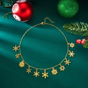 Detail of gold snowflake necklace on green silk with festive Christmas background scenery