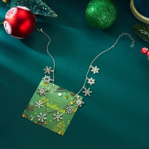 Detailed close-up of a silver snowflake necklace with festive Christmas background scenery