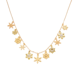 Detail of gold snowflake necklace with sparkling crystal accents and festive pendant charms