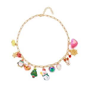 Detail of gold necklace with Christmas charms like snowflake, penguin, and reindeer