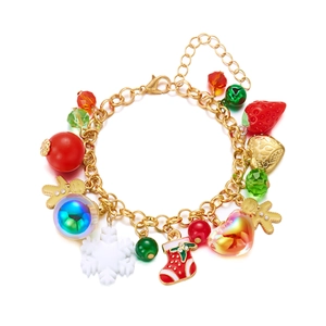 Detail view of a golden Christmas charm bracelet with snowflake and reindeer pendants