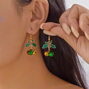 Detail view of festive Christmas holly leaf earrings with red and green metal bells