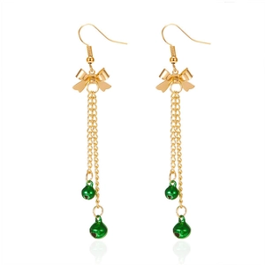 Detail of Christmas earrings featuring gold bow and green bells on long tassel chains