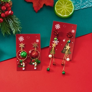 Kerst thema hangende oorbellen met feestelijke bellen en parels op een kerstachtergrond