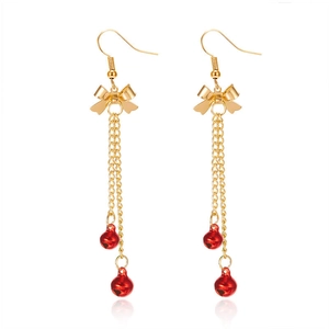 Elegant gold bow earrings with long tassels and festive red bells on white background