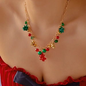 Détail d'un collier de Noël avec perles rouges vertes et cloches dorées sur le cou