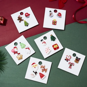 Christmas brooch set featuring Santa, reindeer and tree motifs on festive display card