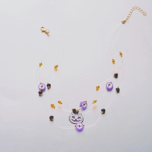 Detailed view of triple-layer Halloween necklace with purple cat face pendant and beads