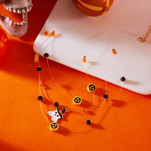 Detailed view of multilayer Halloween necklace featuring a cute ghost charm and orange beads