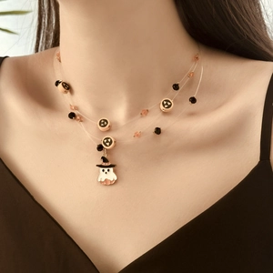 Detail of multilayer Halloween necklace with orange beads and white ghost pendant