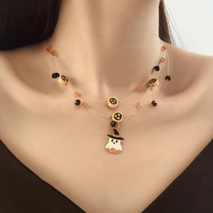 Detail of Halloween layered necklace featuring ghost pumpkin charms and orange black beads