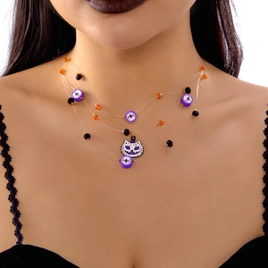 Detail of layered Halloween necklace with cat pumpkin pendant and purple spider beads