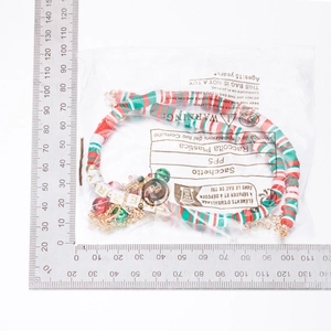Detailed view of festive Christmas beaded necklace with Merry cubes and colorful bells