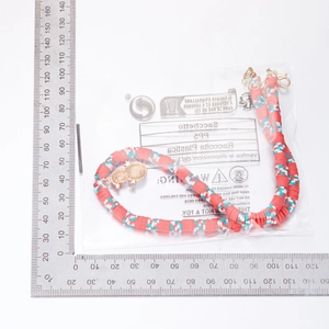 Detailed view of handmade beaded Christmas necklace length measurement with frog pendant