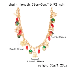 Detailed view of Christmas necklace with snowflake, bell, and reindeer charms in gold