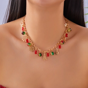 Detail of Christmas necklace with gold charms like Santa Claus and snowflakes on a model