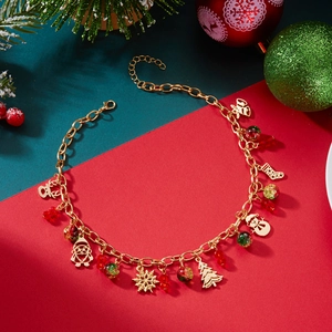 Macro detail of Christmas necklace with gold Santa, reindeer, and festive charms