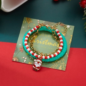 Detail of Christmas bracelet set with Santa charm and colorful Heishi beads on a festive card