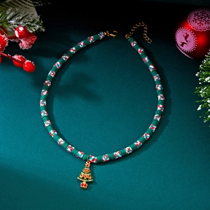 Detail of Christmas tree pendant on festive red and green Heishi bead double layer necklace