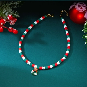 Close-up of Christmas necklace featuring festive heishi beads and a holiday wreath pendant