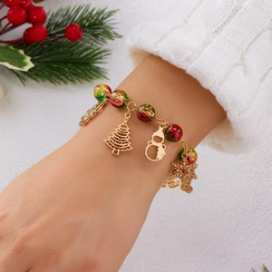 Festive Christmas bracelet with Santa, tree, and snowflake charms worn on a wrist