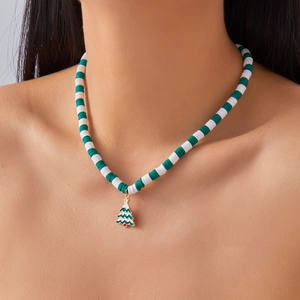 Detailed view of Christmas tree pendant on green and white heishi bead necklace